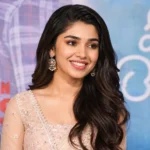Krithi Shetty smiling at a movie promotion event