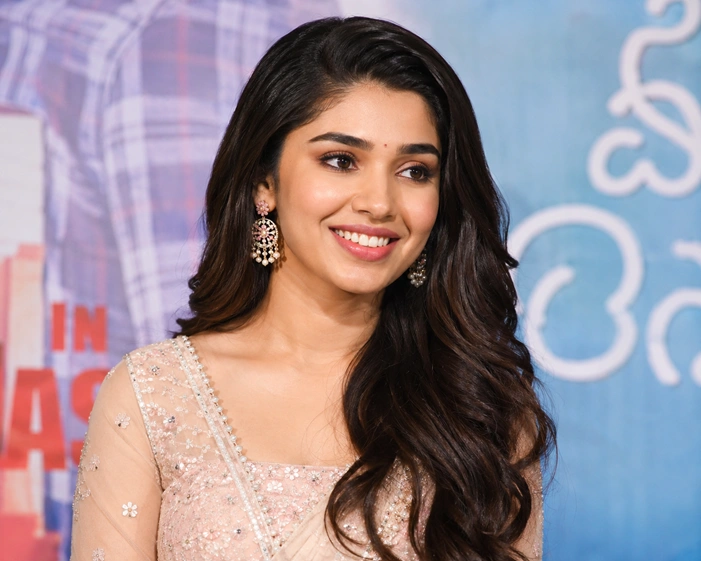 Krithi Shetty smiling at a movie promotion event